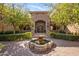 Stately stone facade frames the main entrance and water feature of this luxury home at 6876 S Star Dr, Gilbert, AZ 85298