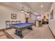 Basement game room features a pool table, arcade games, and a wet bar at 6876 S Star Dr, Gilbert, AZ 85298