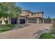 Three-car garage with dark brown doors and a gated entryway at 6876 S Star Dr, Gilbert, AZ 85298