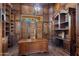 Luxurious home office with custom wood paneling, built-in shelving, and large desk, perfect for working at home at 6876 S Star Dr, Gilbert, AZ 85298