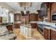 Gourmet kitchen featuring custom cabinets, stainless steel appliances, island, and granite countertops at 6876 S Star Dr, Gilbert, AZ 85298