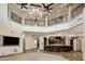 Open-concept living area with a bar and wrought iron balcony overlooking the space at 6876 S Star Dr, Gilbert, AZ 85298
