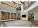 Open living area with soaring ceilings, a stone fireplace, shuttered windows, and wrought iron staircase at 6876 S Star Dr, Gilbert, AZ 85298
