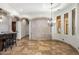 Elegant living room featuring arched entryways, stone accent wall, tiled floor, and chandelier lighting at 6876 S Star Dr, Gilbert, AZ 85298
