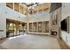 Spacious living room boasts a stone fireplace, large windows, and glass doors to the outdoor patio at 6876 S Star Dr, Gilbert, AZ 85298
