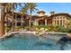 Resort style pool and spa with swaying palms perfect for outdoor entertaining in this luxury home at 6876 S Star Dr, Gilbert, AZ 85298