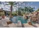 Resort-style pool with a rock waterfall and lounge chairs at 6876 S Star Dr, Gilbert, AZ 85298