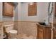 Powder room with stone wall, vessel sink, and dark wood vanity at 6876 S Star Dr, Gilbert, AZ 85298