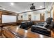 Home theater with tiered seating, wood trim, and a large projector screen for immersive entertainment at 6876 S Star Dr, Gilbert, AZ 85298