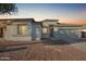 House exterior at dusk, showcasing a neutral color scheme and landscaping at 6924 W Southgate Ave, Phoenix, AZ 85043