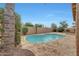 Relaxing kidney-shaped pool with stone patio at 7261 E Black Rock Rd, Scottsdale, AZ 85255