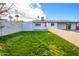 View of backyard with grass and pool at 7432 E Latham St, Scottsdale, AZ 85257