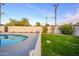 Landscaped backyard with grassy lawn and a pool at 7432 E Latham St, Scottsdale, AZ 85257