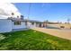 Backyard view showcasing a grassy lawn and pool at 7432 E Latham St, Scottsdale, AZ 85257