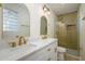 Elegant bathroom featuring double sinks, gold fixtures, and a walk-in shower at 7432 E Latham St, Scottsdale, AZ 85257