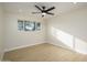 Bedroom with ceiling fan and large window at 7432 E Latham St, Scottsdale, AZ 85257