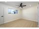 Bright bedroom with ceiling fan and wood floors at 7432 E Latham St, Scottsdale, AZ 85257