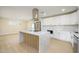 Modern kitchen with white cabinets, stainless steel appliances and island at 7432 E Latham St, Scottsdale, AZ 85257