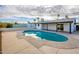 Inviting kidney-shaped pool with a spacious concrete patio at 7432 E Latham St, Scottsdale, AZ 85257