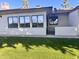 Rear view of the house showcasing a large window and grassy yard at 8020 E Keats Ave # 327, Mesa, AZ 85209