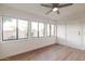 Sunroom with wood-look floors, multiple windows, and ceiling fan at 8020 E Keats Ave # 327, Mesa, AZ 85209