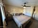 King-size bed, ceiling fan, and wood-like dresser at 8103 E Southern Ave # 52, Mesa, AZ 85209