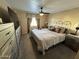 Spacious bedroom with king-size bed and ceiling fan at 8103 E Southern Ave # 52, Mesa, AZ 85209