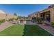 Landscaped backyard with artificial turf and patio at 8202 W Merriweather Way, Florence, AZ 85132