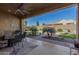 Covered patio with seating area and fire pit at 8202 W Merriweather Way, Florence, AZ 85132