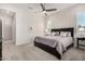 Spacious bedroom with king-size bed, neutral decor, and ceiling fan at 8202 W Merriweather Way, Florence, AZ 85132