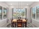 Bright dining room with a wooden table and chairs, and view to backyard at 8202 W Merriweather Way, Florence, AZ 85132