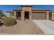 Single-story home with stone accents and two-car garage at 8202 W Merriweather Way, Florence, AZ 85132