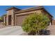 Single story home with stone accents and two car garage at 8202 W Merriweather Way, Florence, AZ 85132