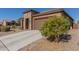 Home's exterior with driveway and neatly manicured landscaping at 8202 W Merriweather Way, Florence, AZ 85132