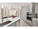 Modern kitchen with gray cabinets, an island with sink, and stainless steel appliances at 8202 W Merriweather Way, Florence, AZ 85132