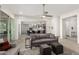 Open living room showcasing a gray sofa, and an open concept view into the kitchen at 8202 W Merriweather Way, Florence, AZ 85132