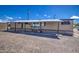 Mobile home with carport and gravel driveway at 9310 E Main St # 182, Mesa, AZ 85207