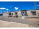 Tan mobile home exterior with gravel landscaping and palm trees at 9310 E Main St # 182, Mesa, AZ 85207