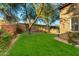 Landscaped backyard with lush green grass and mature trees at 9630 E Mountain Spring Rd, Scottsdale, AZ 85255