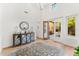 Bright entryway with high ceilings, double doors opening to a courtyard, and an ornate chandelier at 9630 E Mountain Spring Rd, Scottsdale, AZ 85255