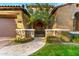 Front view of a two-story home with stone accents and a wrought-iron gate at 9630 E Mountain Spring Rd, Scottsdale, AZ 85255