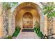 Elegant double wooden doors with stone arch entryway at 9630 E Mountain Spring Rd, Scottsdale, AZ 85255