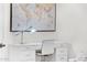 White home office features a world map, desk, and comfortable chair at 9630 E Mountain Spring Rd, Scottsdale, AZ 85255