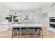 Large kitchen island with seating, white cabinets and quartz countertops at 9630 E Mountain Spring Rd, Scottsdale, AZ 85255