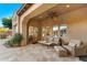 Covered patio boasts comfortable seating and views of the backyard at 9630 E Mountain Spring Rd, Scottsdale, AZ 85255