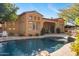 Luxury home with inviting pool, expansive patio, and outdoor kitchen at 9630 E Mountain Spring Rd, Scottsdale, AZ 85255