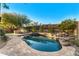 Stunning kidney-shaped pool with a waterfall feature and spacious patio at 9630 E Mountain Spring Rd, Scottsdale, AZ 85255