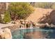 Serene waterfall feature flows into a refreshing pool at 9630 E Mountain Spring Rd, Scottsdale, AZ 85255