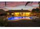 Sunset view of backyard with a sparkling pool and patio at 1007 W Armstrong Way, Chandler, AZ 85286