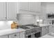 Modern kitchen featuring white cabinets, a gas cooktop, and quartz countertops at 1007 W Armstrong Way, Chandler, AZ 85286